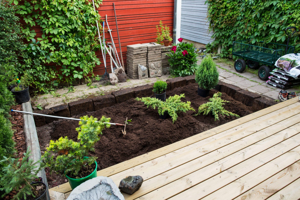 topsoil raised flower bed with rake