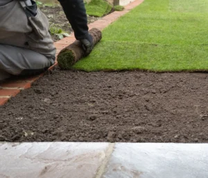 landscaper laying down sod