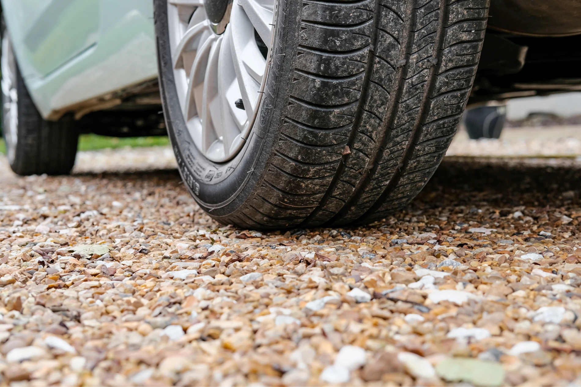 car tire on gravel driveway