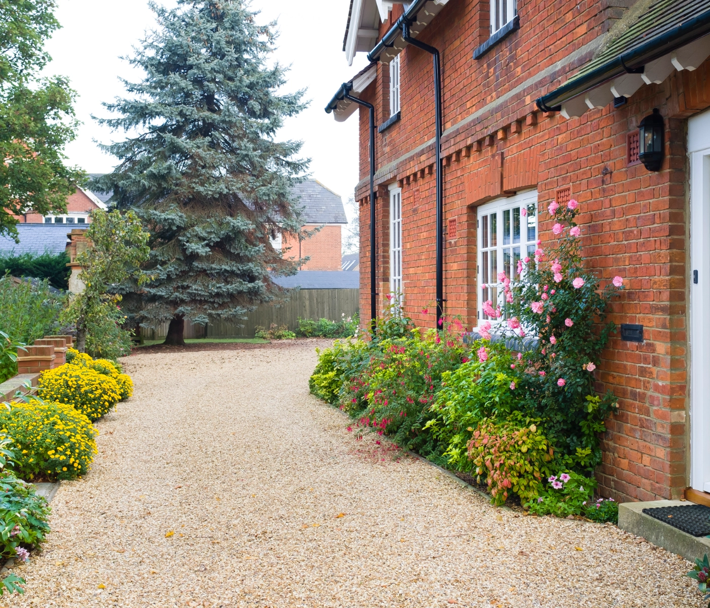 house with pea gravel driveway