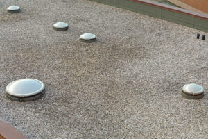 Many Plastic Cover Skylight Window at Gravel Industrial Flat Roof Structure